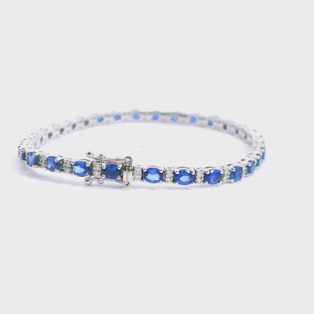 18ct white gold bracelet featuring 31 oval blue sapphires and 62 round brilliant cut diamonds with a box clasp and double figure-eight safety catches.