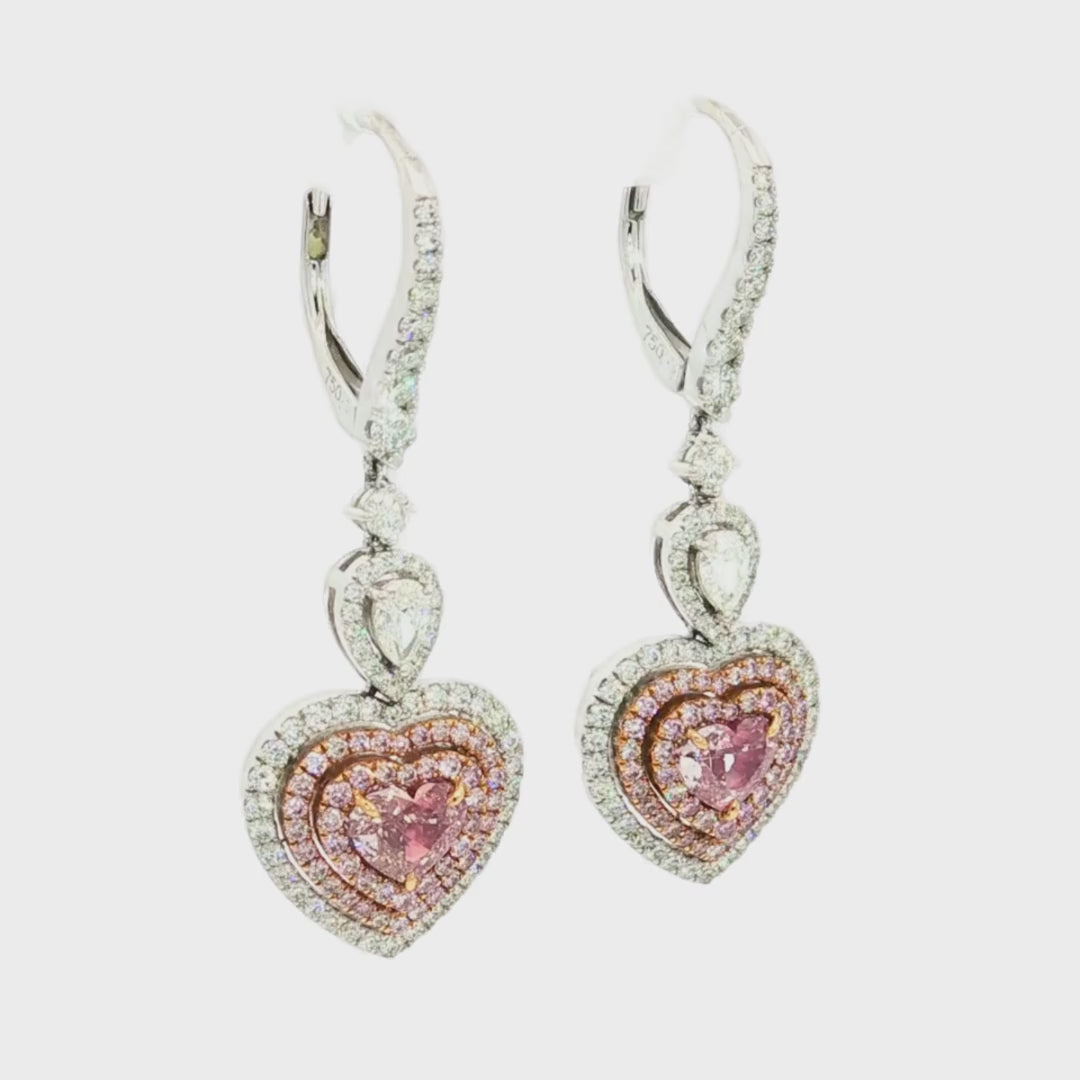 White and rose gold articulated heart-shaped diamond earrings with pink and white diamond triple halo design.