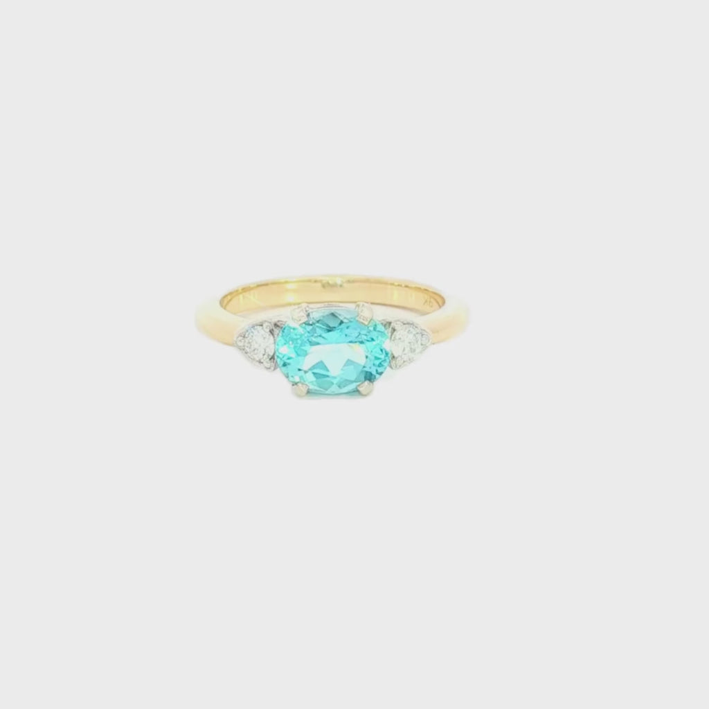 9ct yellow and white gold ring with 1.27ct horizontal oval aquamarine and triangular diamond accents.