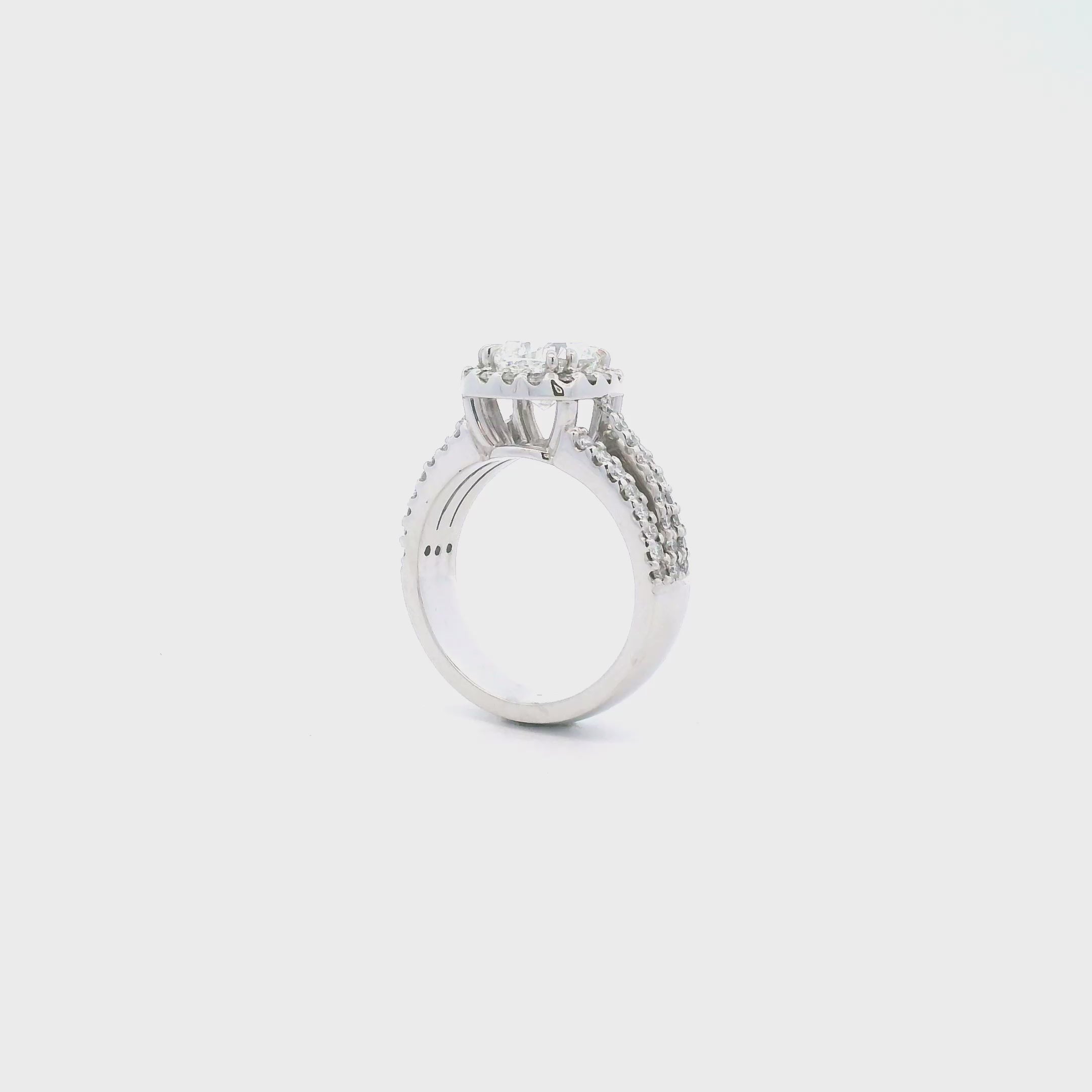 Platinum cushion cut diamond halo ring featuring a 2.00ct centre diamond with a halo surround and triple split diamond-set shoulders.