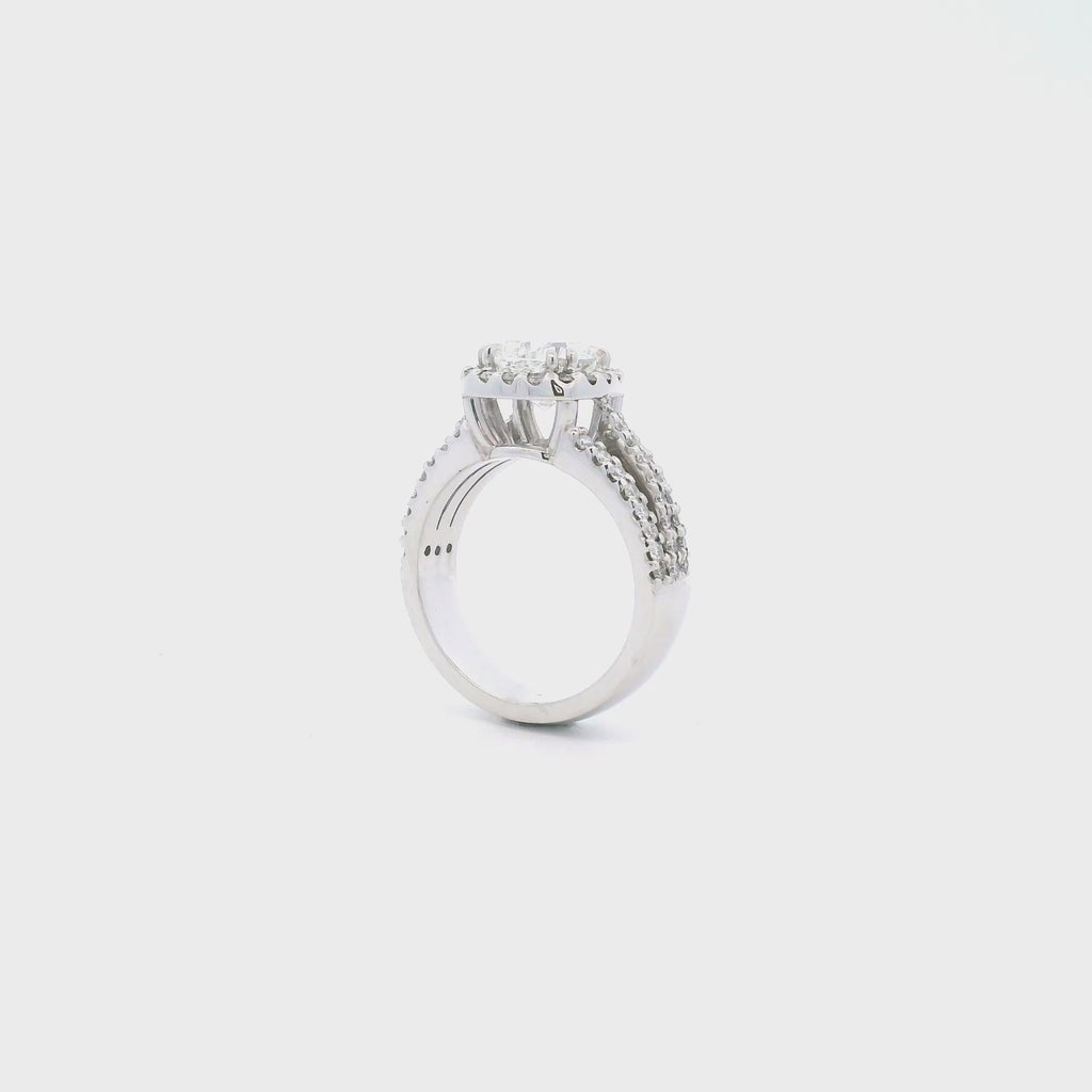 Platinum cushion cut diamond halo ring featuring a 2.00ct centre diamond with a halo surround and triple split diamond-set shoulders.
