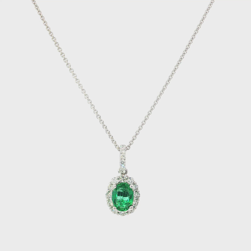 18ct white gold emerald and diamond pendant with oval emerald and halo design