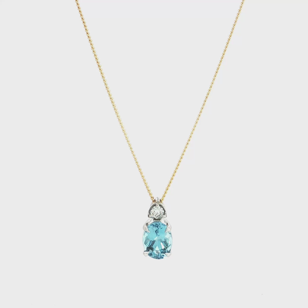 9ct white gold oval aquamarine and diamond pendant with triangular diamond accent.