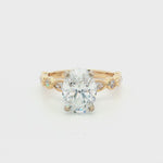 Side view of 2.50ct oval diamond engagement ring showing the white gold centre setting and yellow gold diamond-set shoulders.