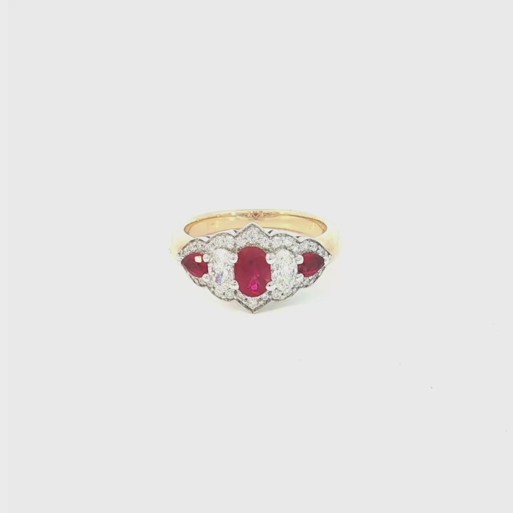 18ct yellow and white gold five-stone ruby and diamond ring featuring alternating claw-set gems with a pointed diamond surround.