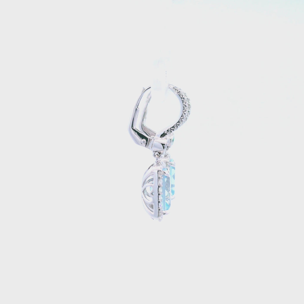 18ct white gold aquamarine and diamond drop earrings featuring cushion cut aquamarines with diamond halos and huggie-style fittings.