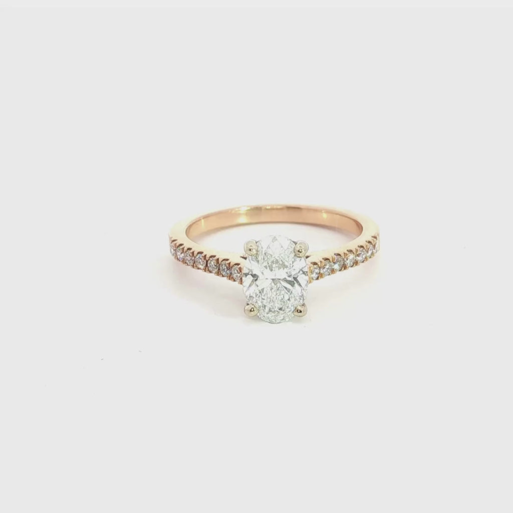18ct rose and white gold diamond ring featuring a 1.02ct round brilliant cut centre diamond with diamond-set shoulders.