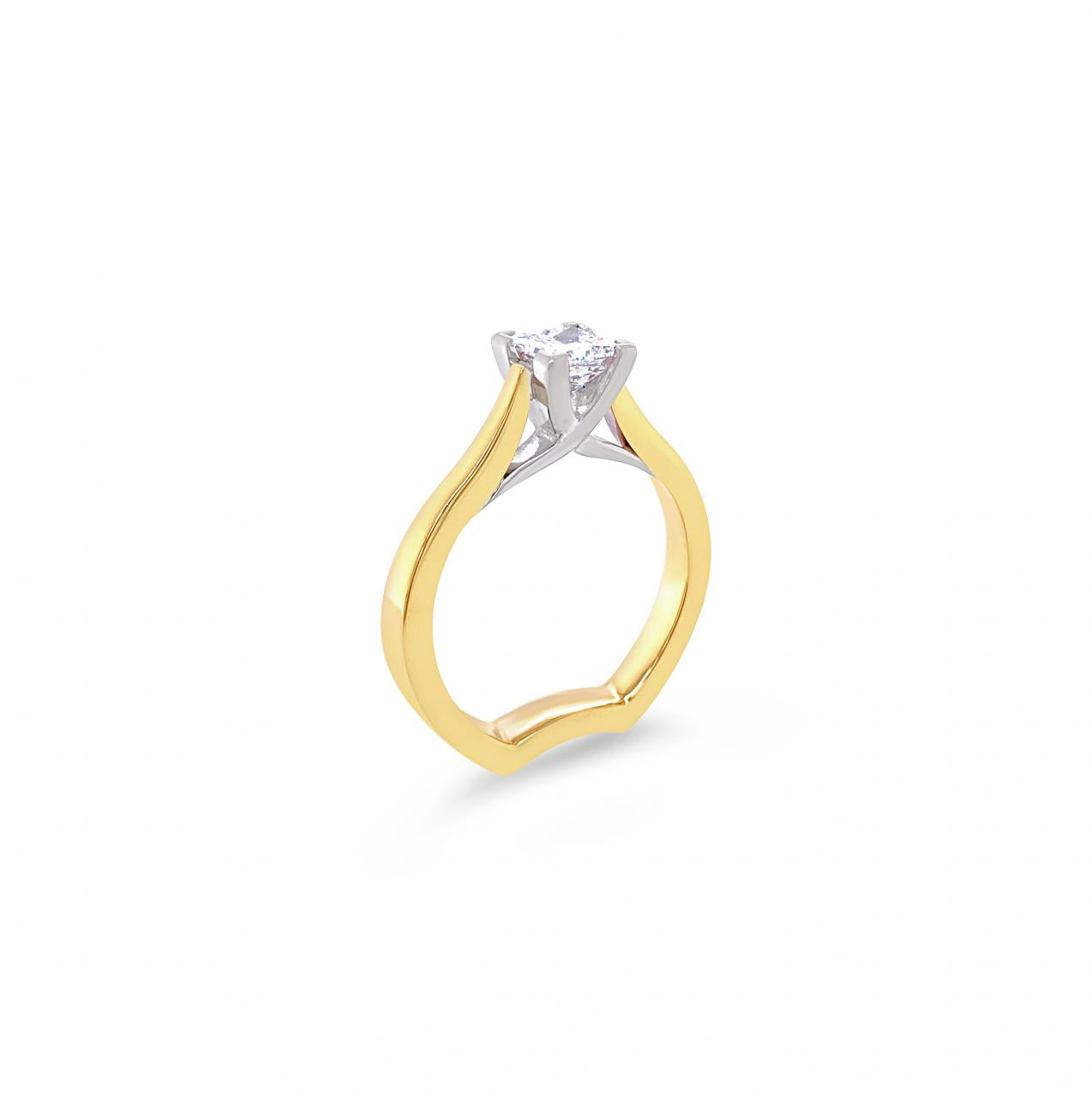 Two-tone yellow and white gold princess cut diamond ring with a crossover collet and curved shank.