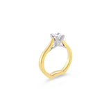 Two-tone yellow and white gold princess cut diamond ring with a crossover collet and curved shank.