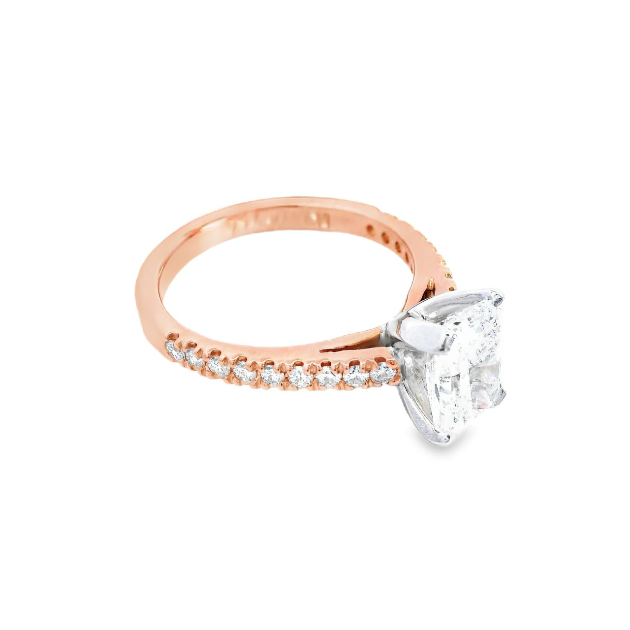 18ct rose gold and platinum diamond ring featuring a 1.50ct radiant cut centre diamond and diamond-set shoulders.