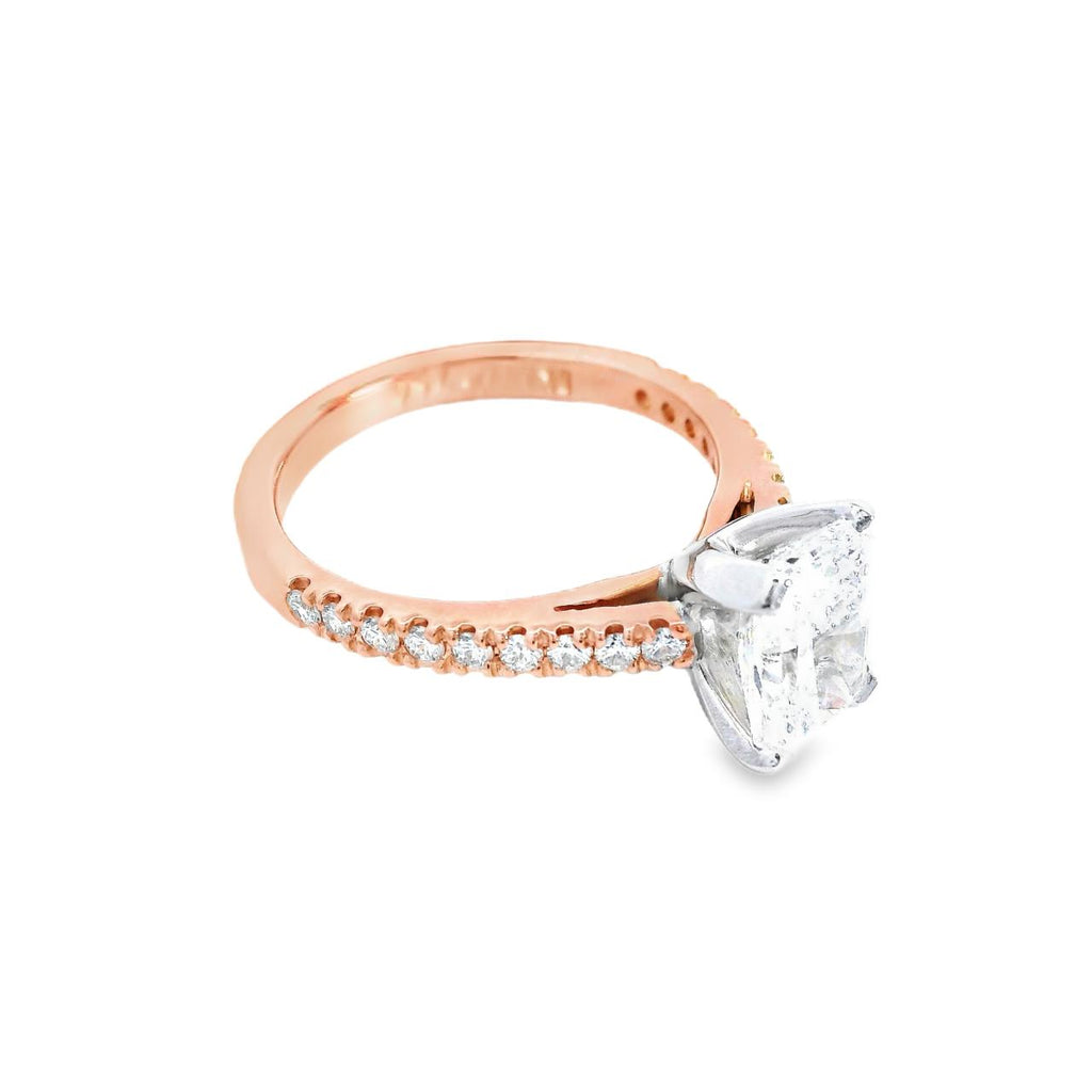 18ct rose gold and platinum diamond ring featuring a 1.50ct radiant cut centre diamond and diamond-set shoulders.