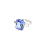 18ct white gold ring featuring a 6.99ct radiant cut tanzanite with two tapered baguette cut diamonds in a tiered three-stone setting.