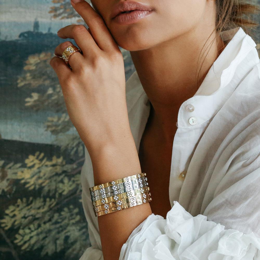 Roberto Coin Love in Verona 18ct white gold diamond bangle with flower cluster settings, engraved floral motifs, and two signature rubies set inside the clasp.