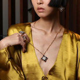 Roberto Coin Princess Flower 18ct rose and white gold necklet featuring a black jade and diamond flower locket pendant with rope detail and signature ruby clasp on 82cm oval link chain.