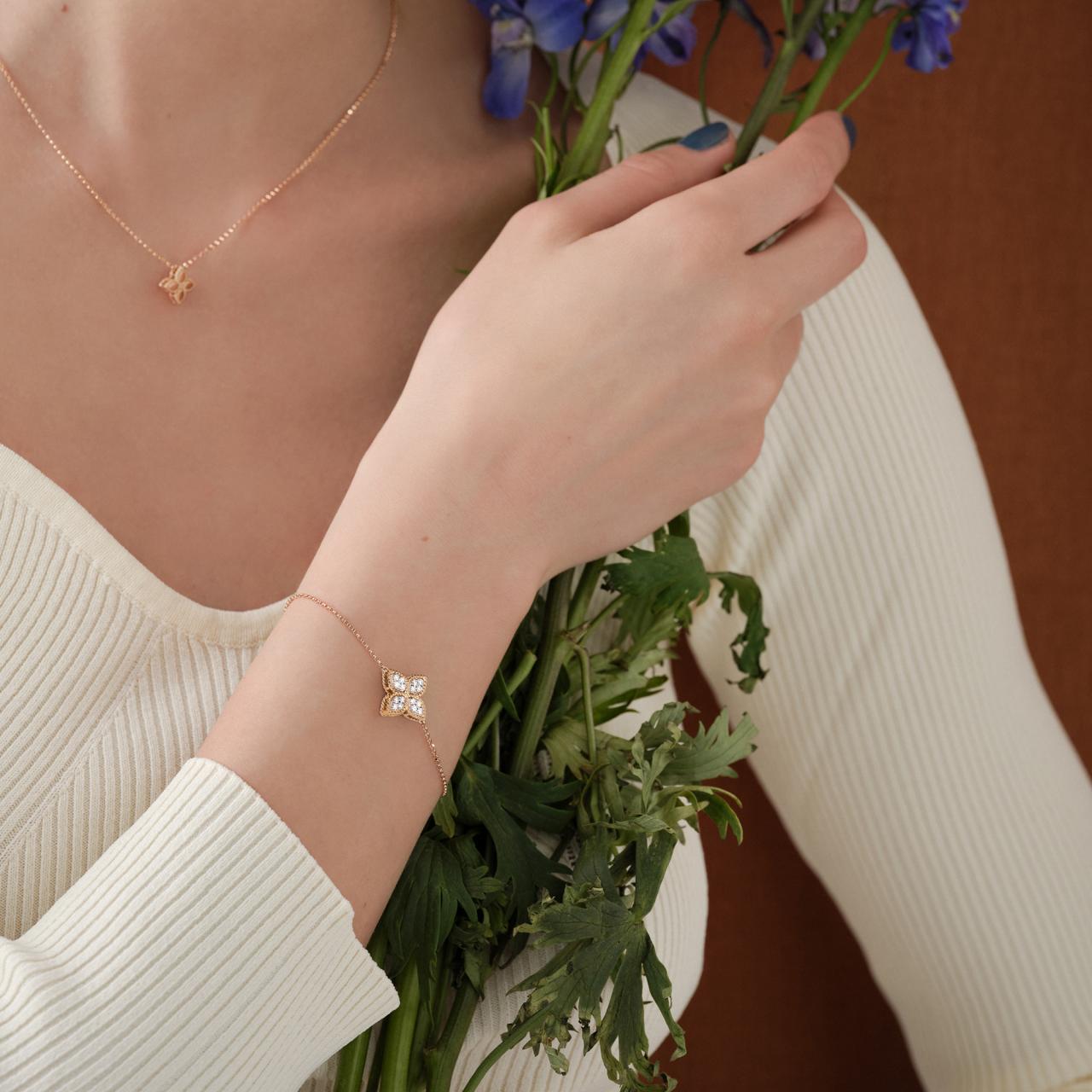 Roberto Coin Princess Flower rose and white gold diamond bracelet with flower motif and ruby clasp.