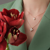 Roberto Coin Princess Flower rose and white gold diamond necklet with bead-set petals and rope detail.