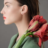 Roberto Coin Princess Flower rose and white gold diamond stud earrings with bead-set petals and rope detail.