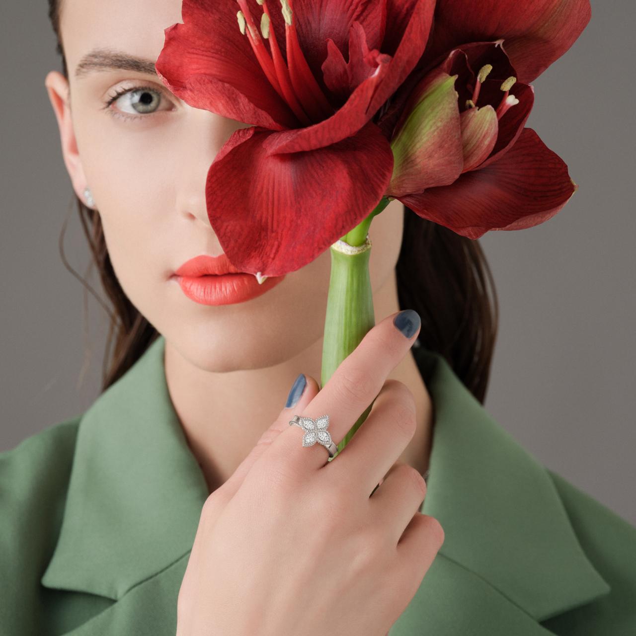 Roberto Coin Princess Flower ring in 18ct white gold featuring four diamond cluster petals, rope edge detailing, and a signature hidden ruby inside the band.