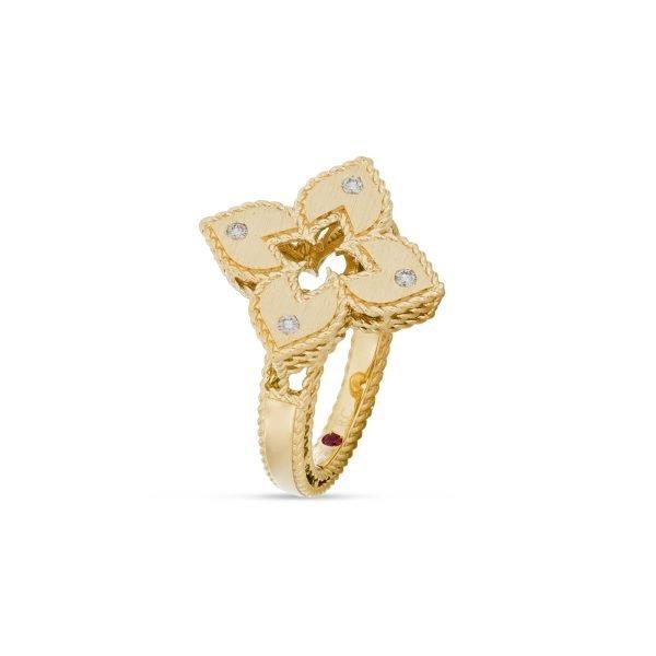 Roberto Coin Venetian Princess ring in 18ct yellow gold with matte finish, featuring an open flower design with diamond-set petals, rope edge detailing, and a hidden ruby inside the shank.
