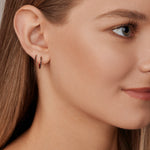 18ct rose gold black diamond huggie earrings with claw-set black diamonds around the front and inside back.