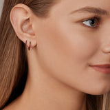 18ct rose gold black diamond huggie earrings with claw-set black diamonds around the front and inside back.