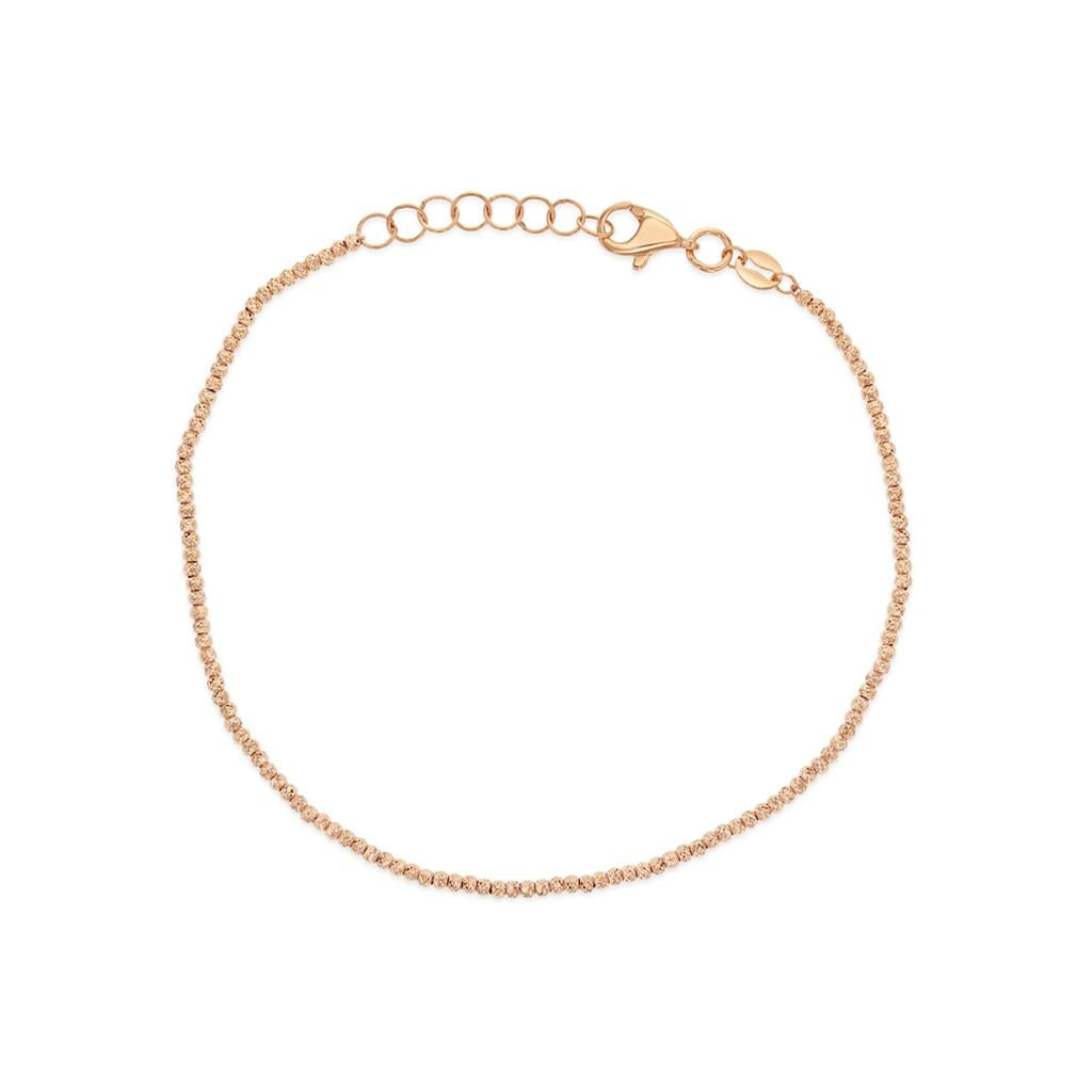 9ct rose gold trace bracelet with small facetted bead detailing.