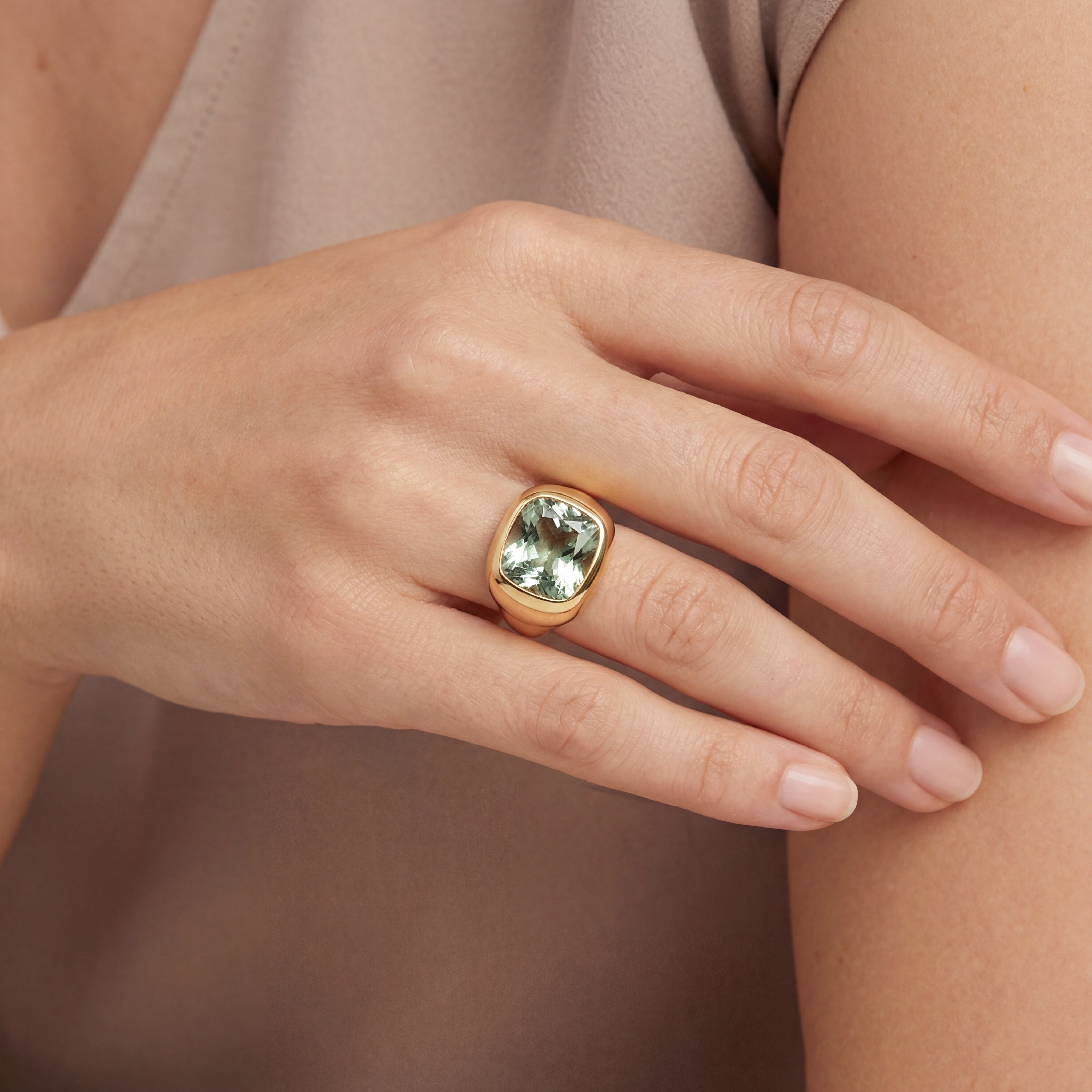 18ct rose gold ring with large bezel-set cushion-cut green quartz in a sculptural puff-top design.