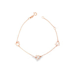 Rose gold trace link bracelet with three mother of pearl butterfly motifs.