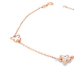 Rose gold trace link bracelet with three mother of pearl butterfly motifs.