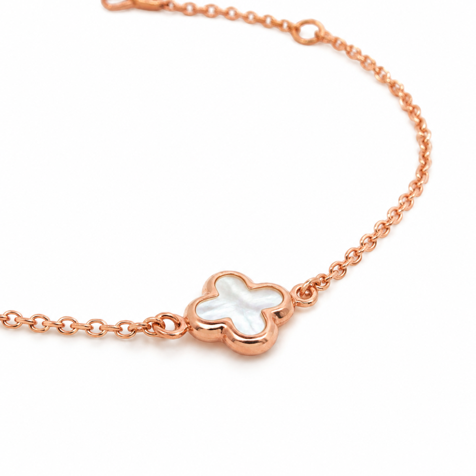 9ct rose gold trace link bracelet with mother of pearl clover centre.