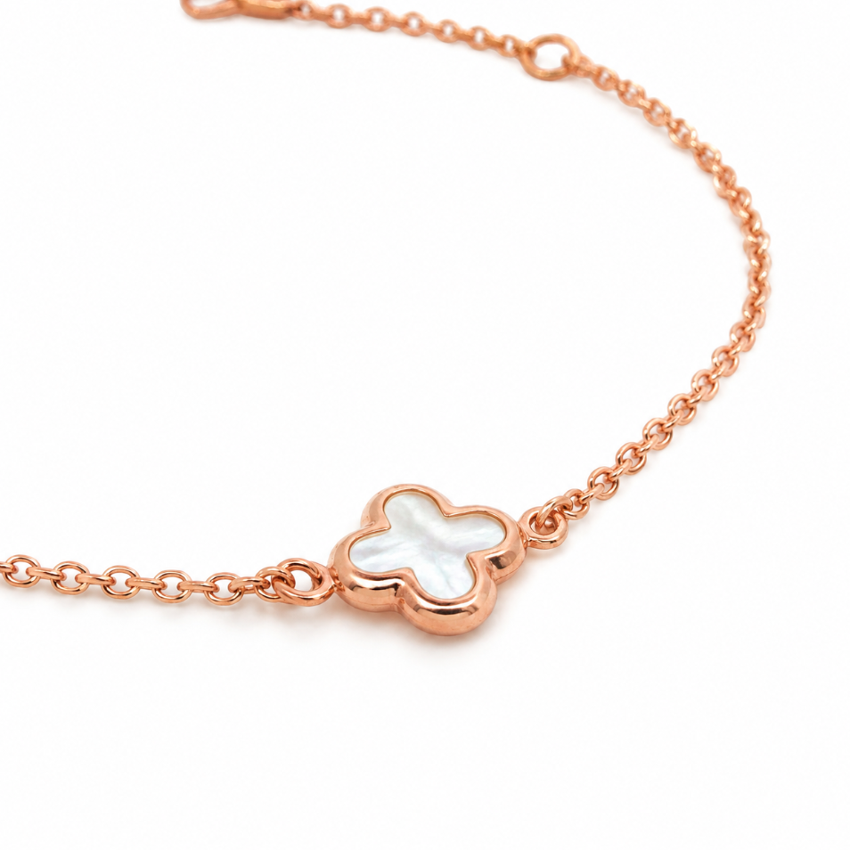 9ct rose gold trace link bracelet with mother of pearl clover centre.
