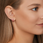 18ct rose gold ruby huggie earrings with claw-set rubies front and back.