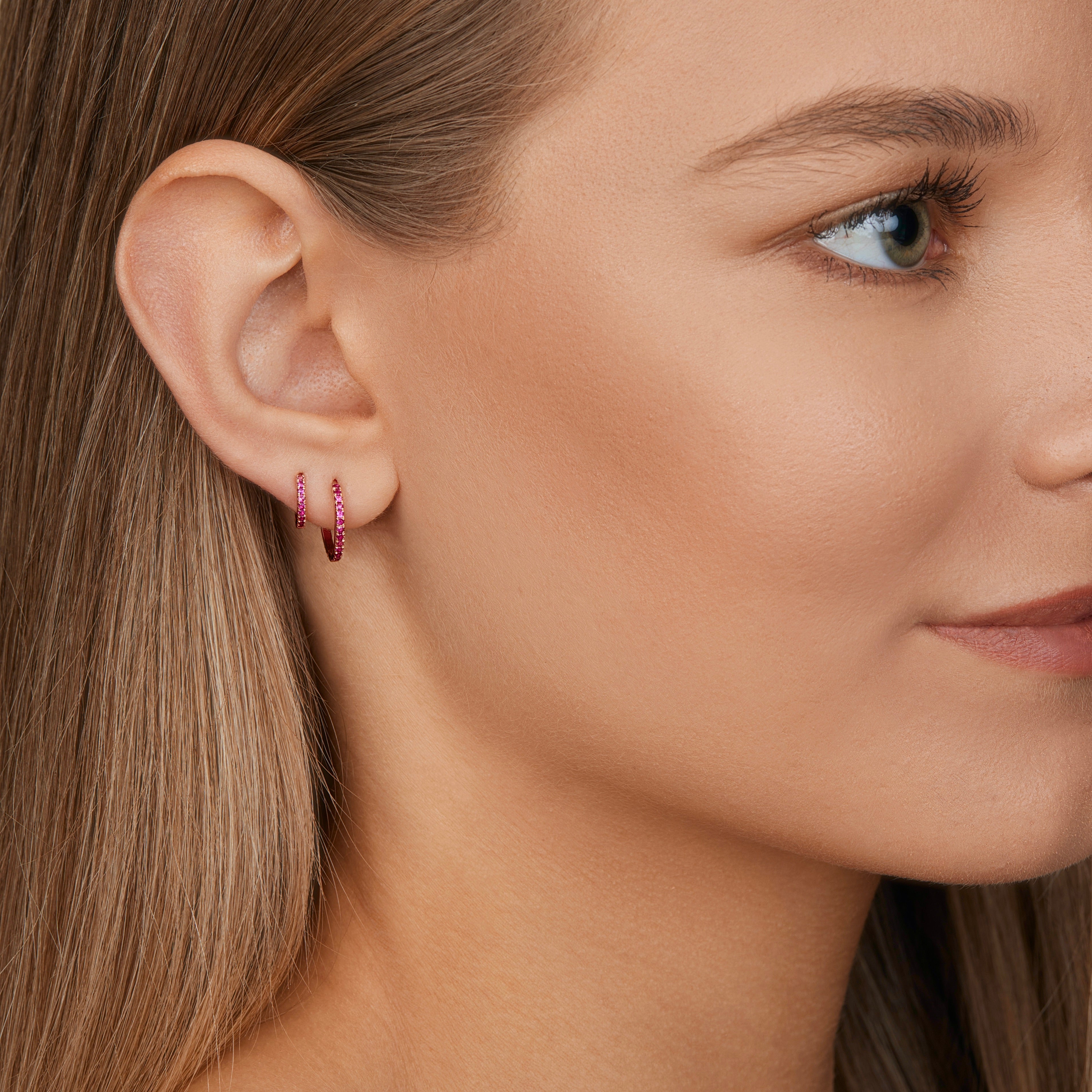 18ct rose gold ruby huggie earrings with claw-set rubies front and back.