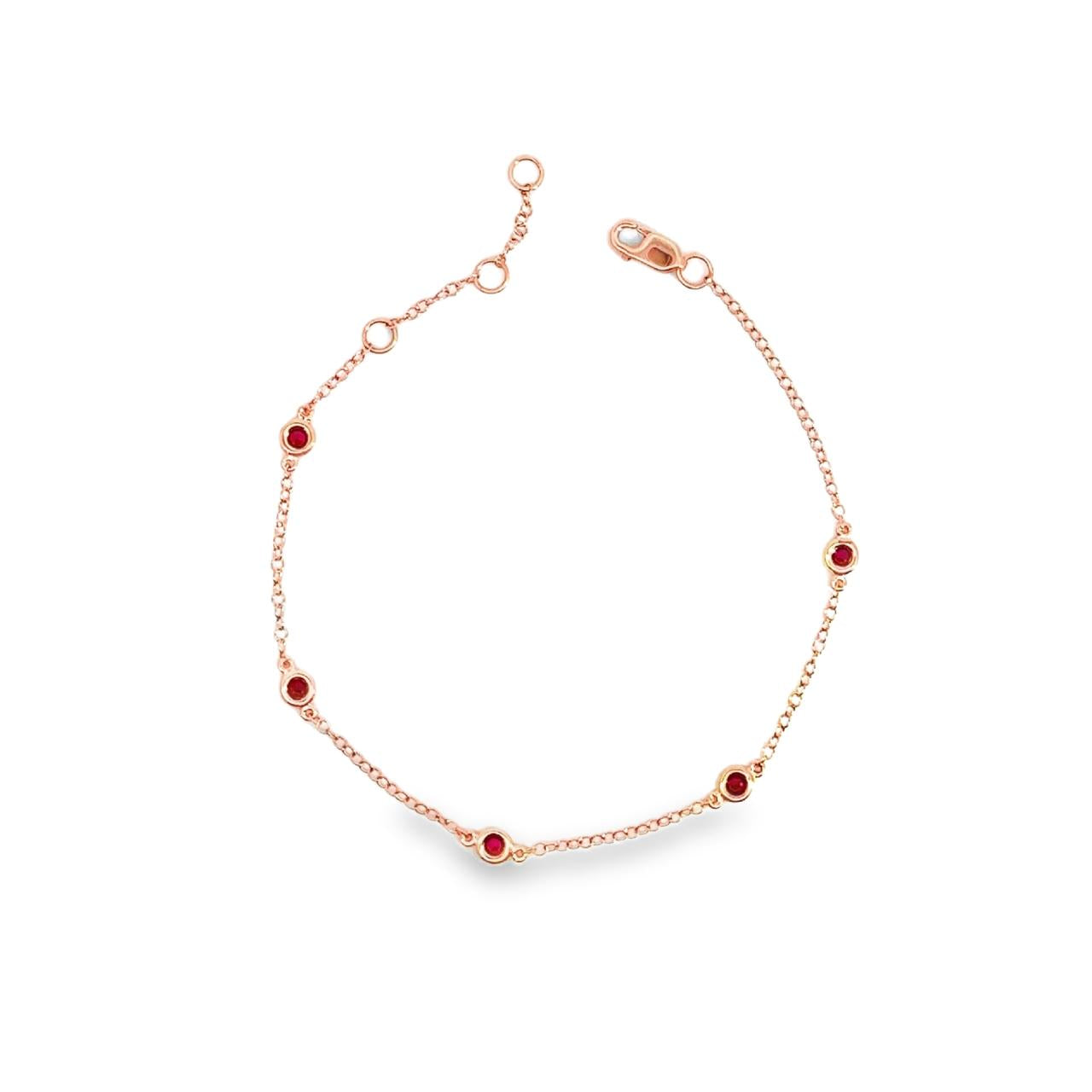 18ct rose gold bracelet with bezel set ruby stations on a fine trace chain.