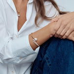 18ct rose gold South Sea pearl and diamond bangle with sweeping diamond-set curves.