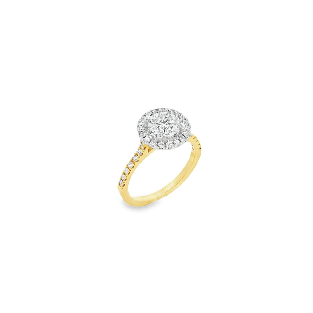 18ct yellow and white gold diamond halo ring featuring a 1.02ct round brilliant cut diamond with a multi-claw halo and diamond-set shoulders.