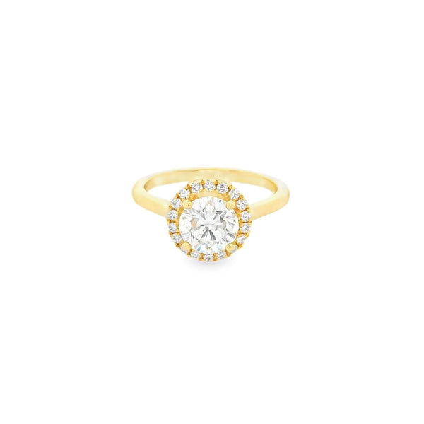 18ct yellow gold diamond halo ring featuring a 1.30ct round brilliant cut centre diamond with a surrounding halo of smaller diamonds.