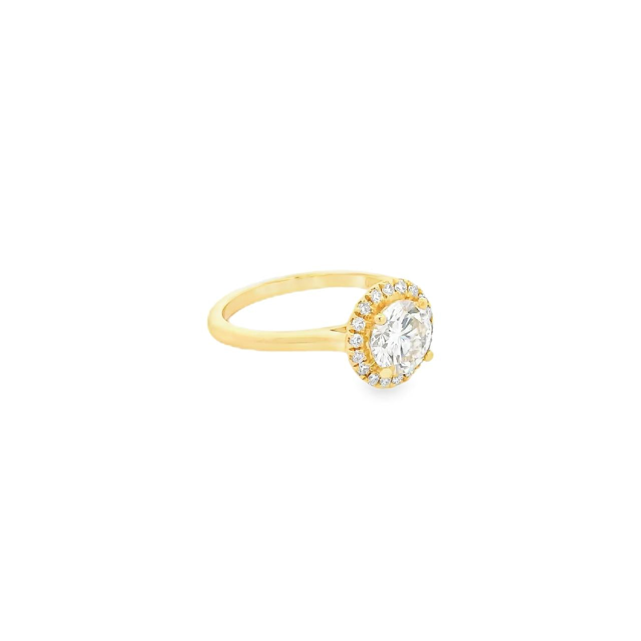 18ct yellow gold diamond halo ring featuring a 1.30ct round brilliant cut centre diamond with a surrounding halo of smaller diamonds.