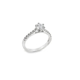 18ct white gold diamond ring with a six-claw 0.70ct round brilliant cut centre diamond and raised claw-set diamond shoulders.