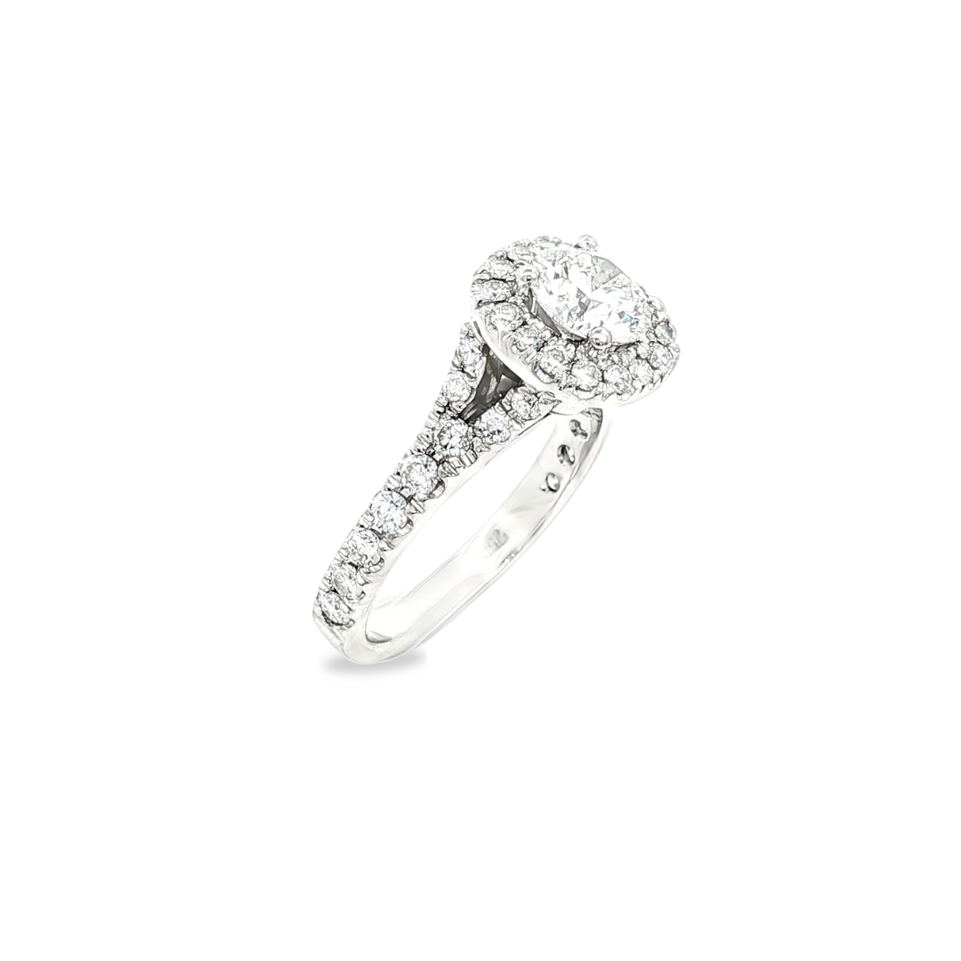 18ct white gold halo diamond ring featuring a round brilliant cut centre diamond with halo and split claw-set diamond shoulders.