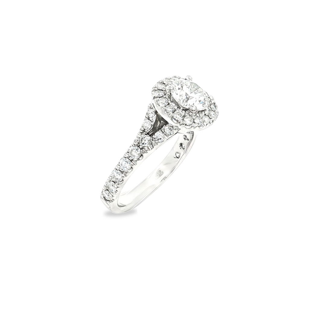 18ct white gold halo diamond ring featuring a round brilliant cut centre diamond with halo and split claw-set diamond shoulders.