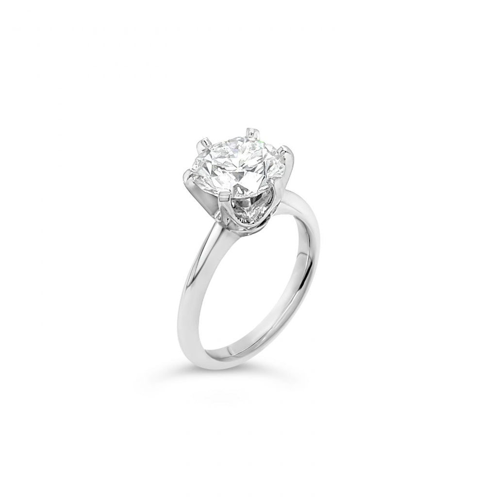 Platinum solitaire diamond ring featuring a 3.01ct round brilliant cut diamond in a six-claw setting.