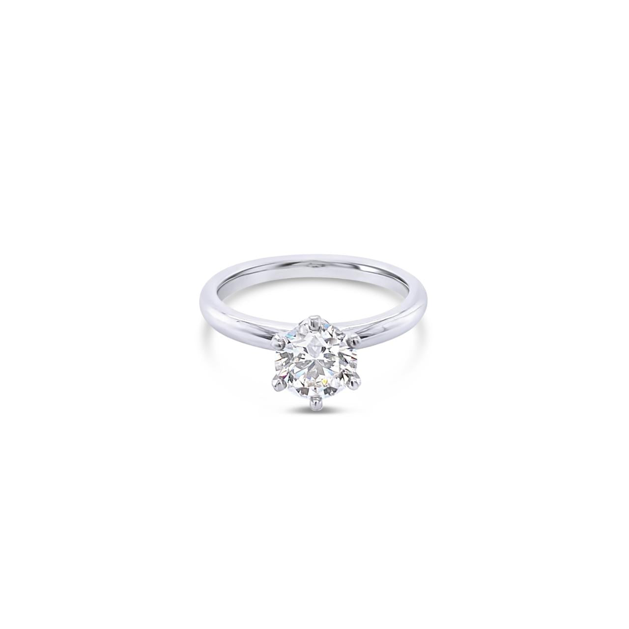 Platinum solitaire diamond ring featuring a 1.06ct round brilliant cut diamond in a six-claw setting.