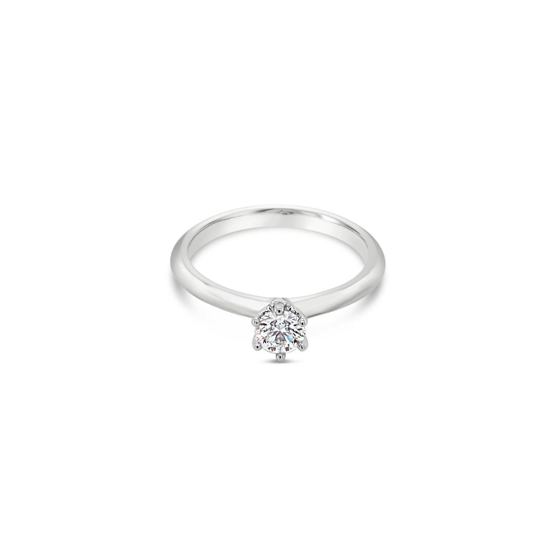 Platinum six-claw solitaire diamond ring featuring a 0.31ct round brilliant cut diamond with a coronet-style cut-out collet.