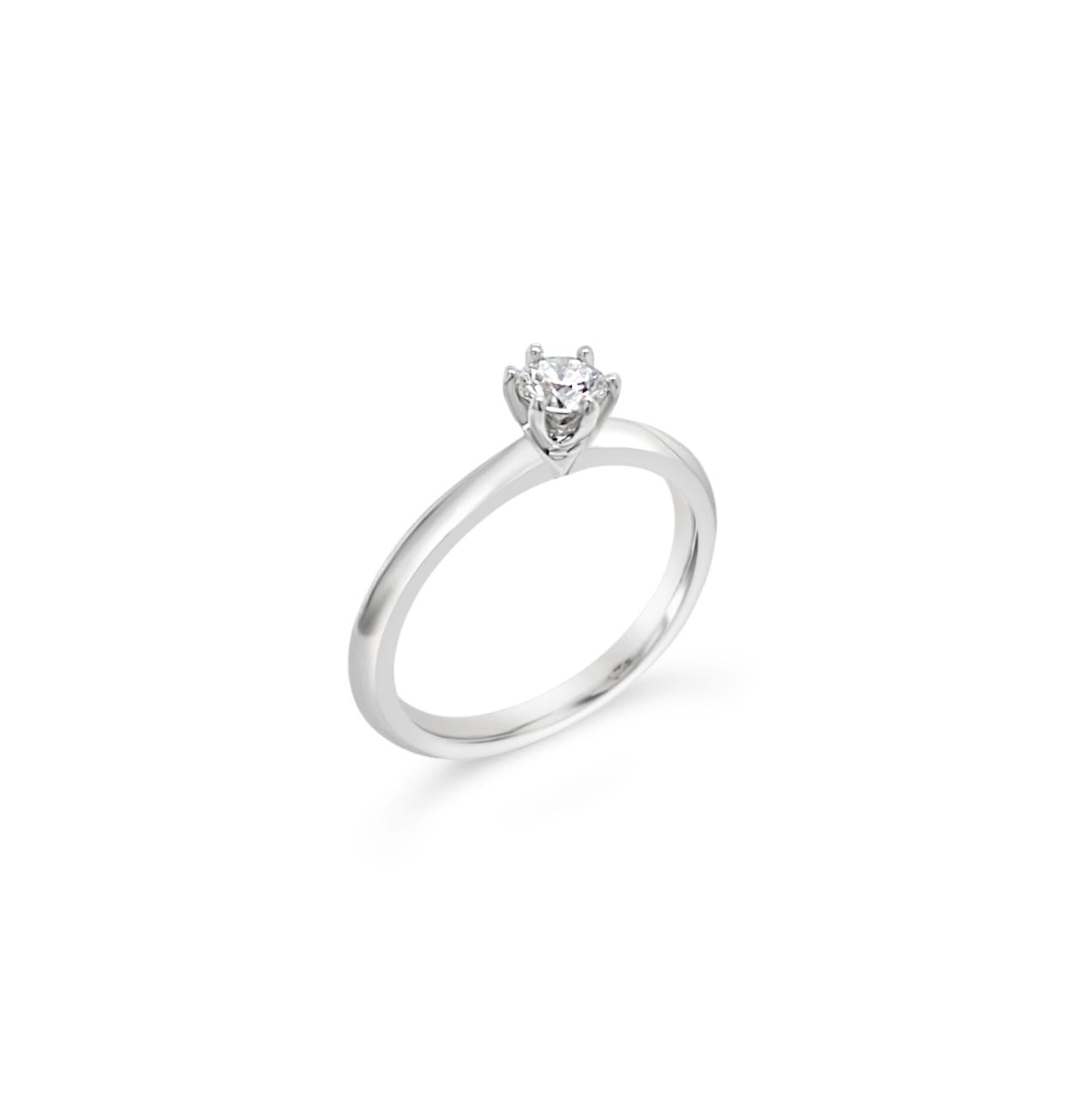 Platinum six-claw solitaire diamond ring featuring a 0.31ct round brilliant cut diamond with a coronet-style cut-out collet.