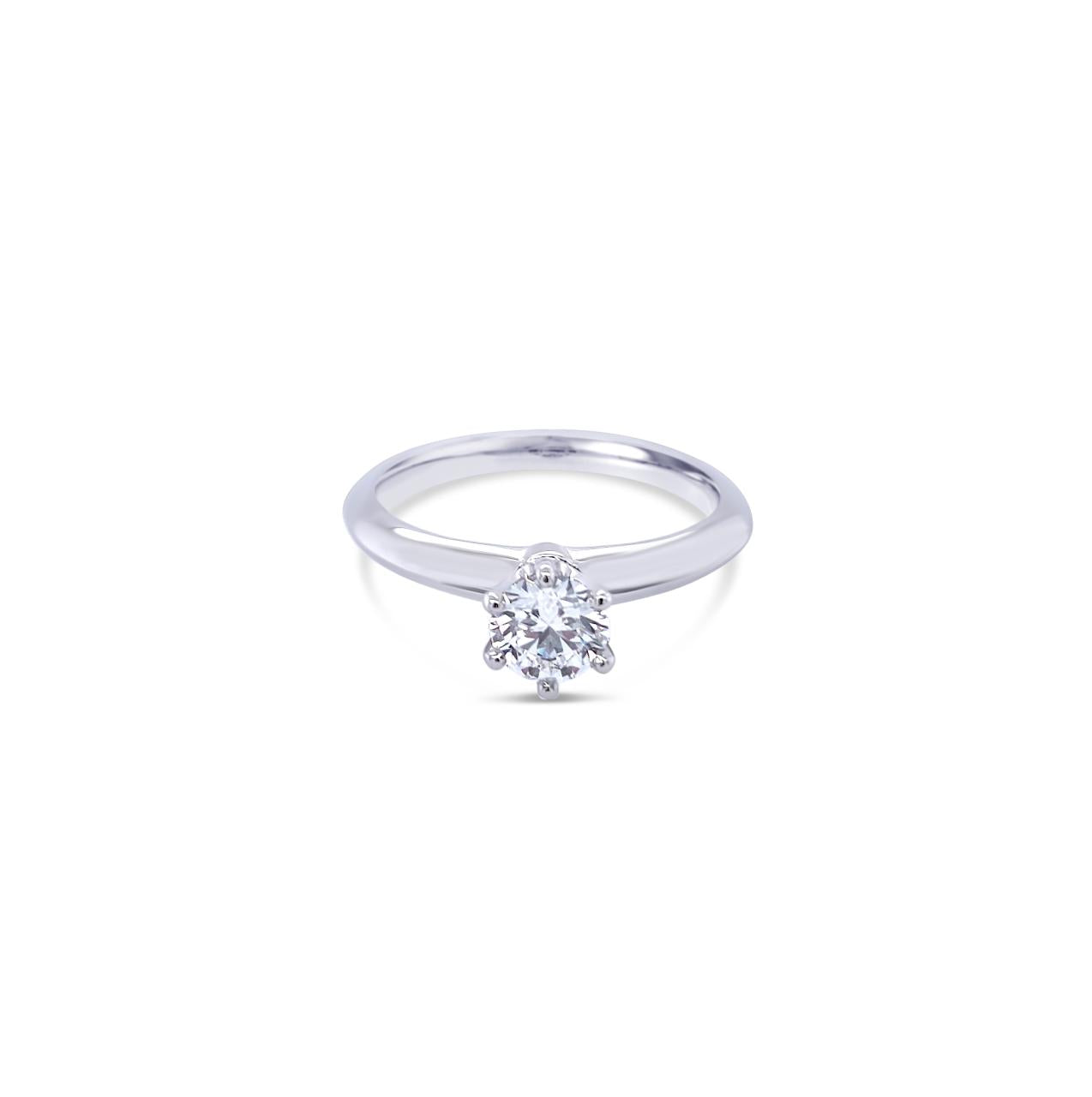 Platinum round brilliant cut 0.50ct solitaire diamond ring with six-claw setting and knife-edge shoulders.