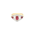 18ct yellow and white gold five-stone ruby and diamond ring featuring alternating claw-set gems with a pointed diamond surround.