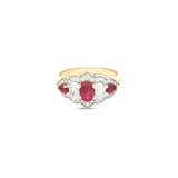18ct yellow and white gold five-stone ruby and diamond ring featuring alternating claw-set gems with a pointed diamond surround.