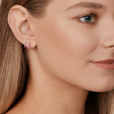 18ct white gold ruby huggie earrings with claw-set round rubies along the front and inside back, 11mm diameter, hinged with clip catch.