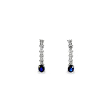 18ct white gold drop earrings with five articulated round brilliant cut diamonds leading to 5x4mm oval-cut sapphire drops, post and butterfly fittings.